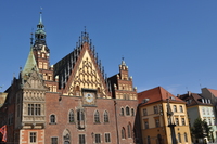 A elaborately decorated old building with towers, spires and a clock.